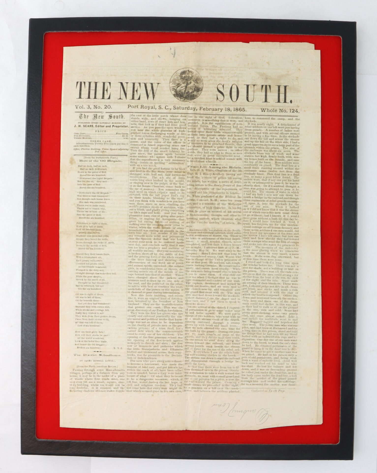 A framed 1865 issue of "The New South" newspaper from Port Royal, South Carolina, displayed on a red background.
