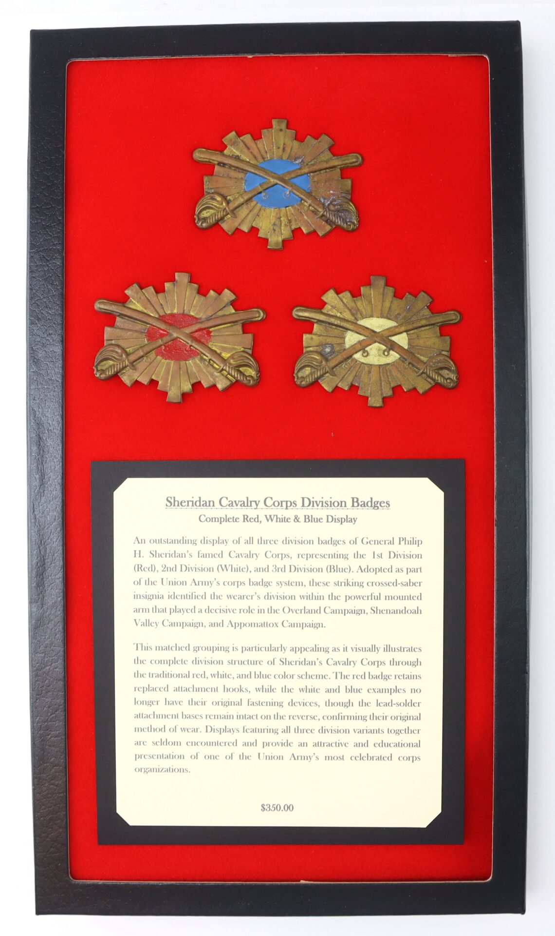 Framed display with three Sheridan Cavalry Corps Division Badges, each featuring a different colored stripe, and a descriptive plaque set on a red background. Price tag reads $250.00.