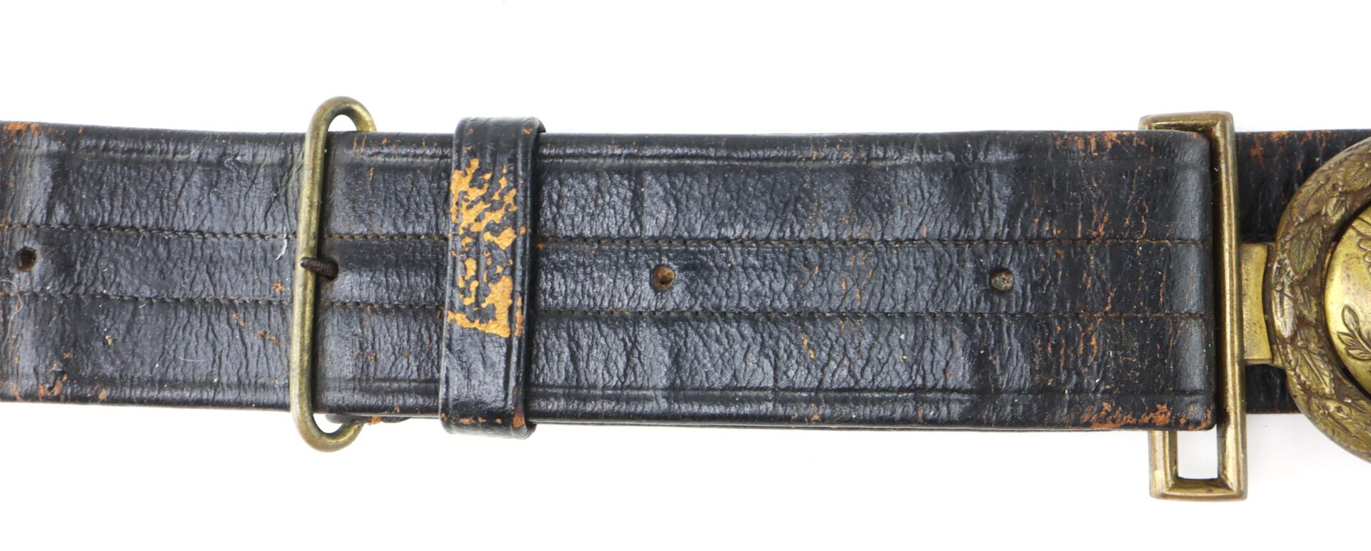 A worn black leather belt with a brass buckle and a circular decorative clasp, showing visible scratches and signs of age.