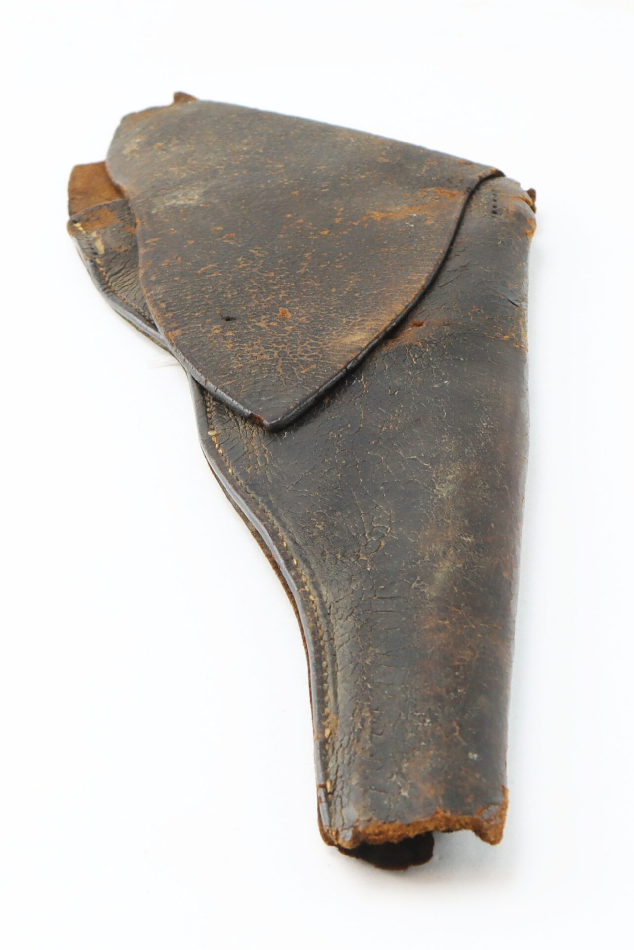 Worn, brown leather gun holster with a flap closure, shown on a plain white background.