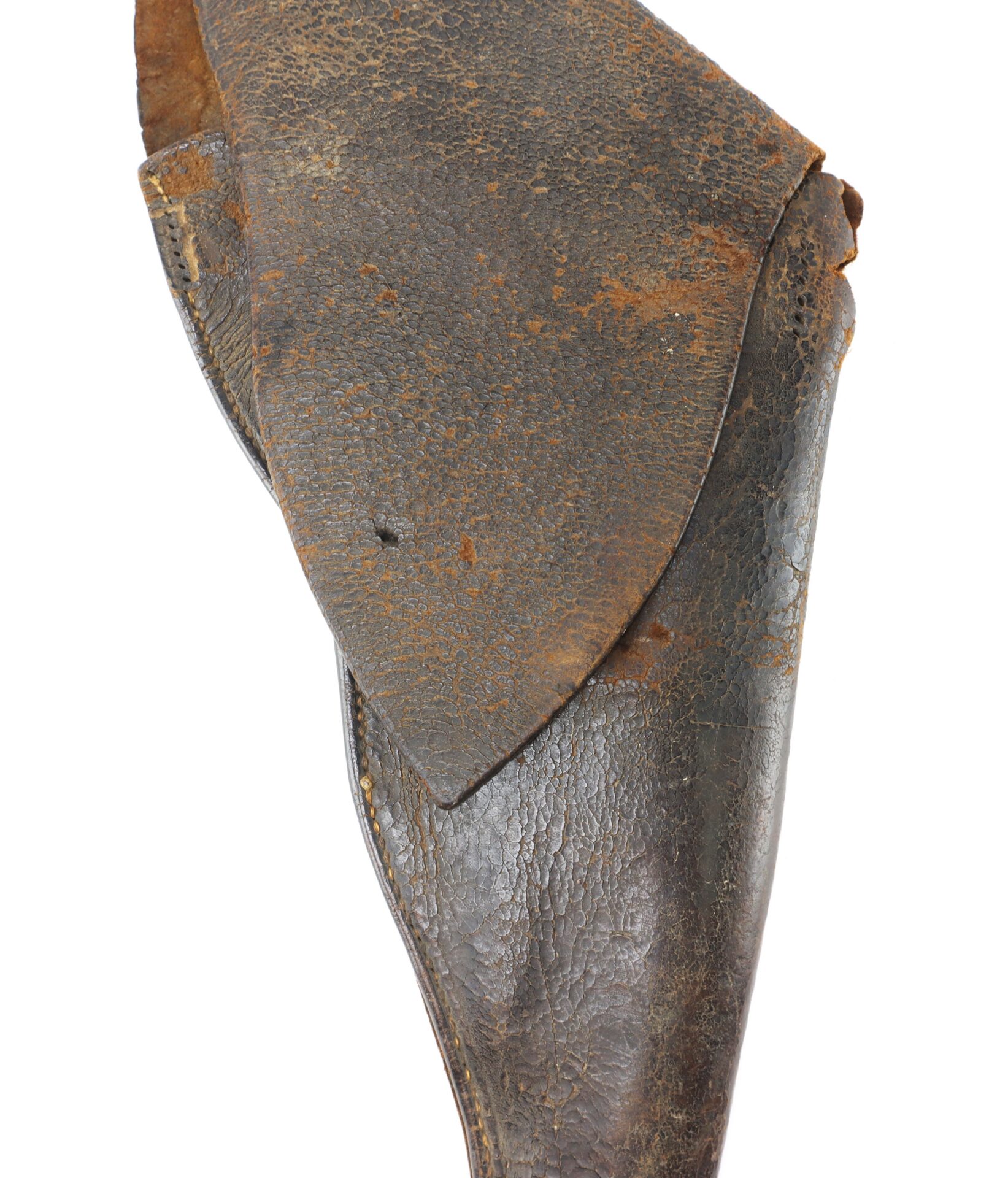 A close-up of a worn, brown leather holster with visible creases, cracks, and rust spots on its surface.