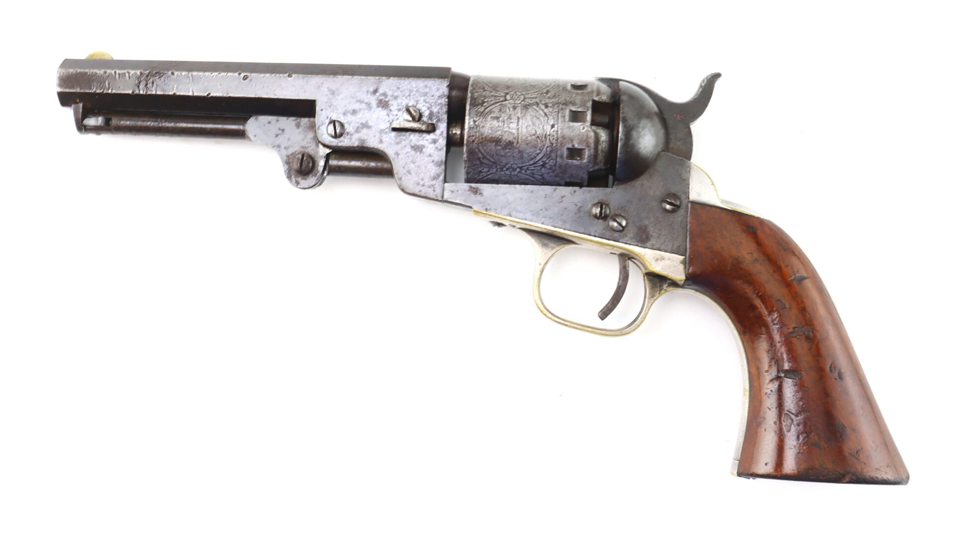 A vintage revolver with a wooden grip, metal frame, and engraved cylinder, photographed on a white background.