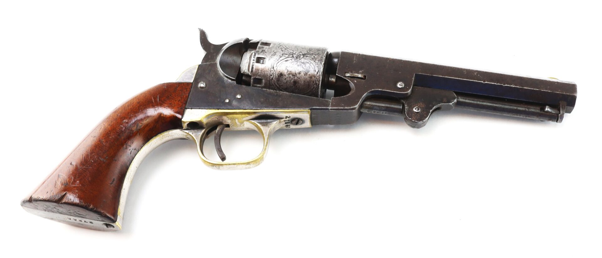 A vintage revolver with a wooden handle and engraved metal cylinder is shown lying on a white background.