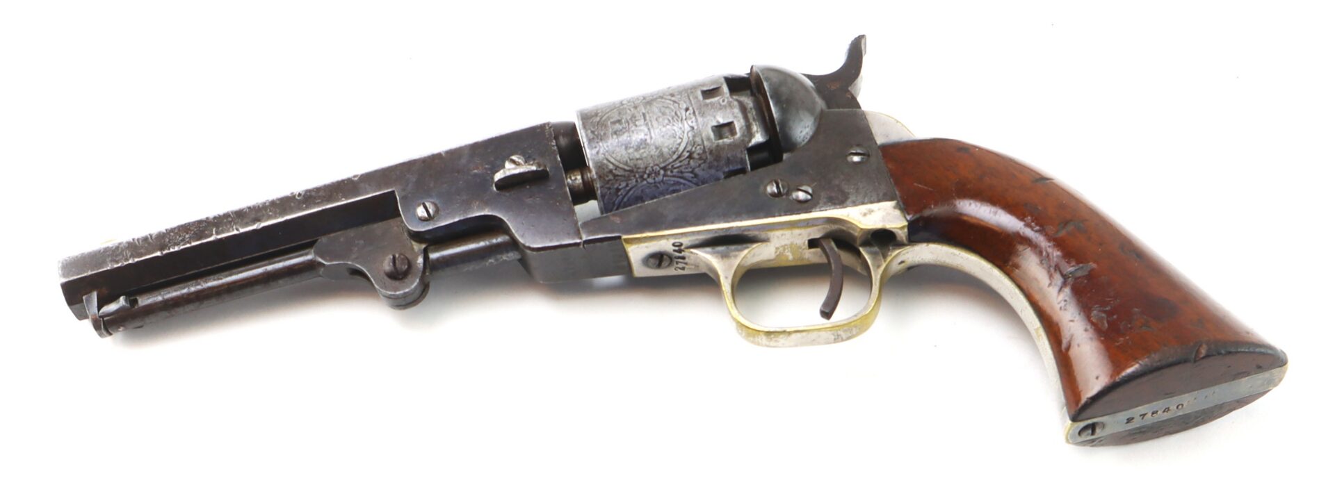 A vintage Colt revolver with a wooden grip, decorated cylinder, and metal barrel is shown on a white background.