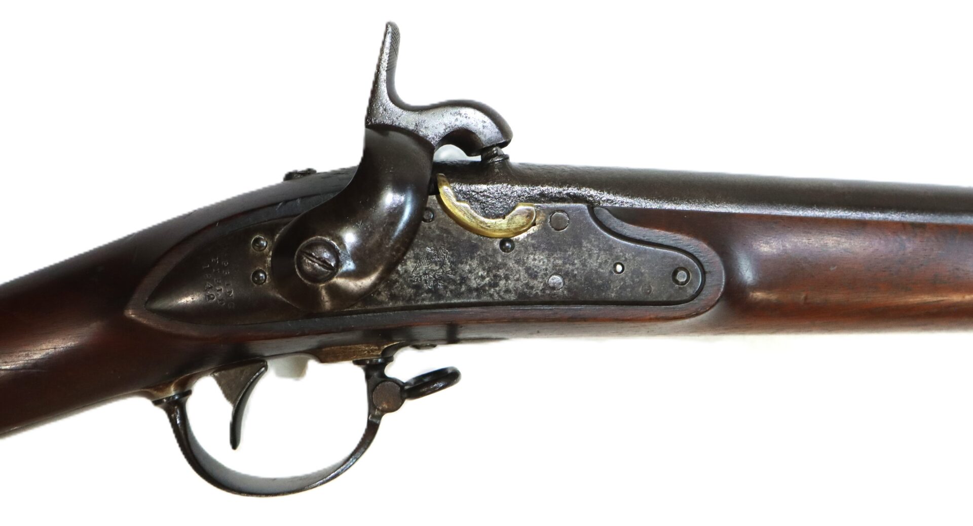 Side view of an antique muzzle-loading percussion rifle with a wooden stock, exposed hammer, and metal trigger guard, set against a white background.