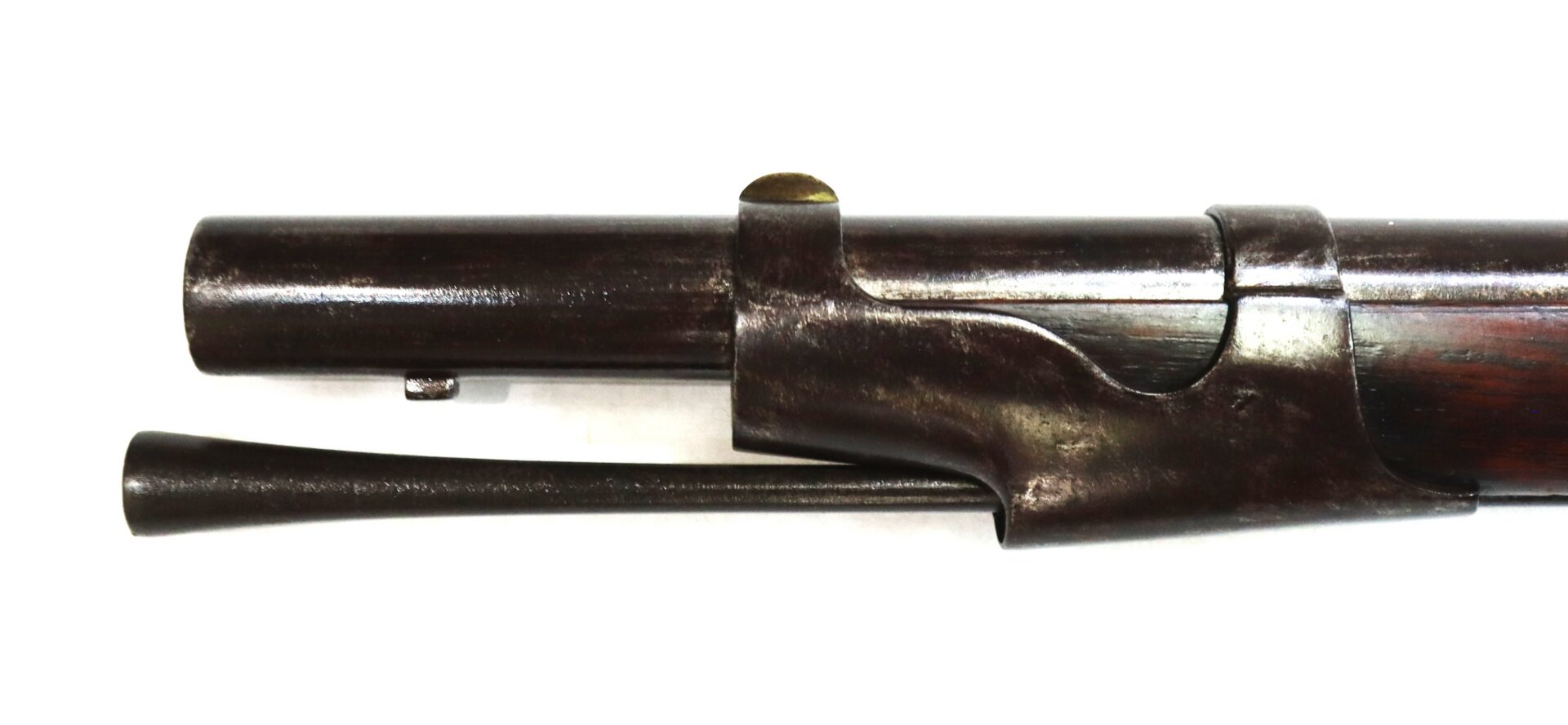 Close-up of the barrel and cleaning rod of a vintage rifle against a plain white background.