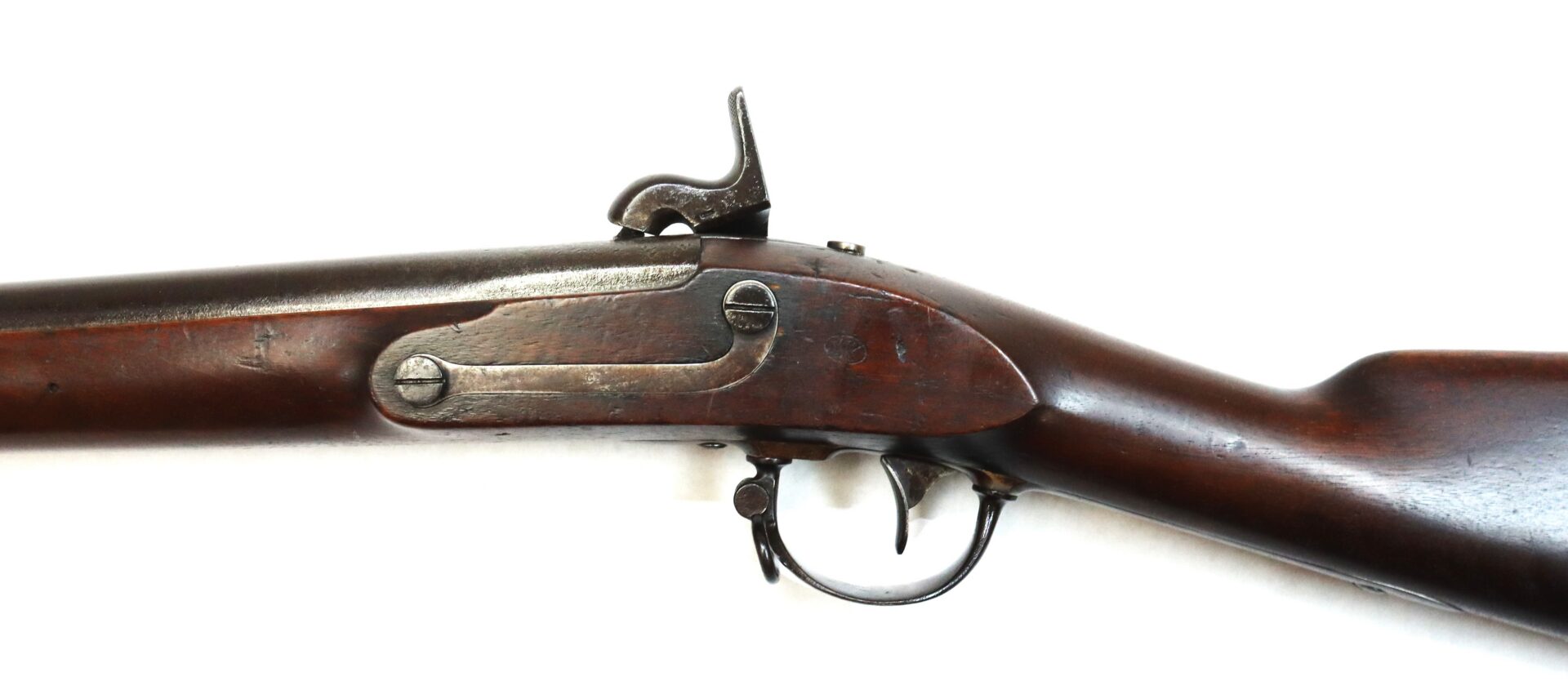 Side view of an antique percussion cap rifle with a wooden stock and metal trigger, shown against a white background.
