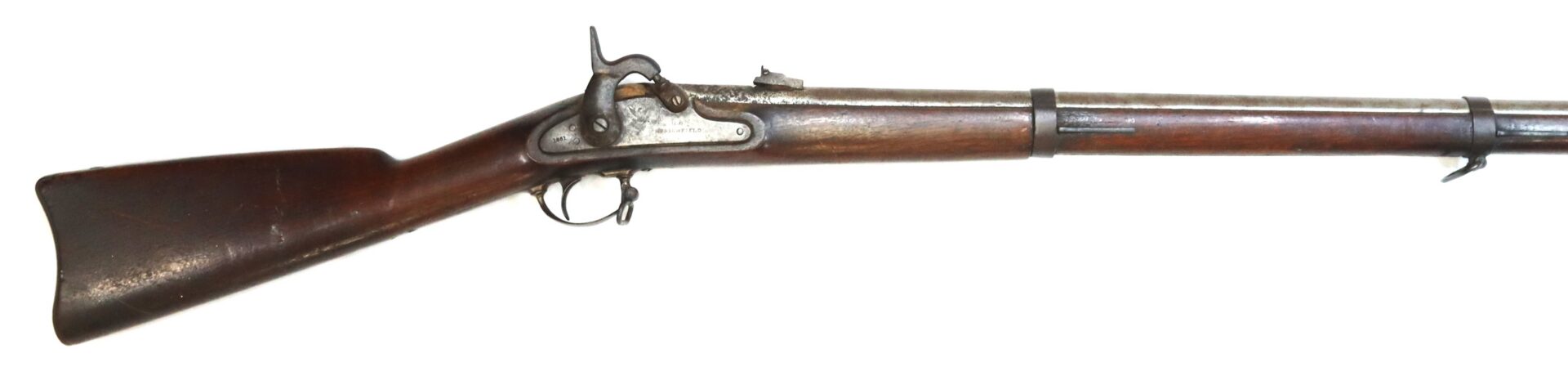 Side view of an antique percussion cap rifle with a wooden stock and a metal barrel, showing signs of age and wear.