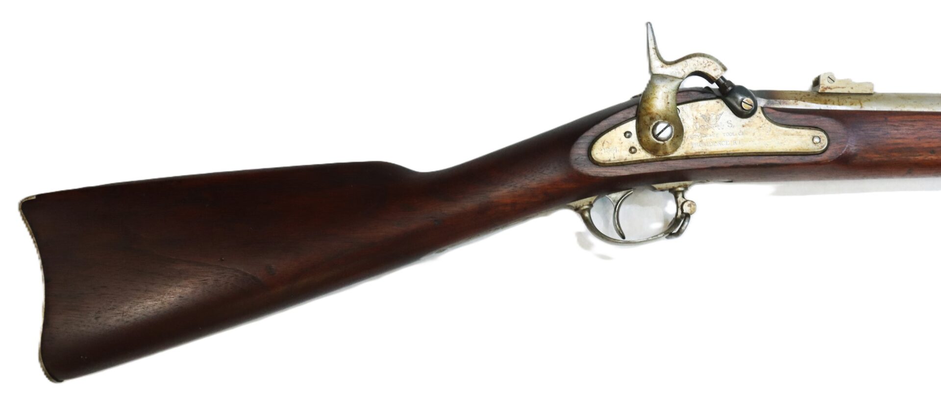 Side view of the wooden stock and metal lock mechanism of an antique muzzle-loading rifle.