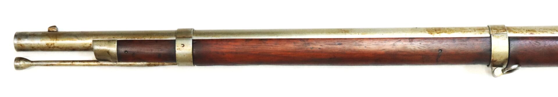 A close-up view of the barrel and wooden stock of an antique bolt-action rifle with metal fittings.