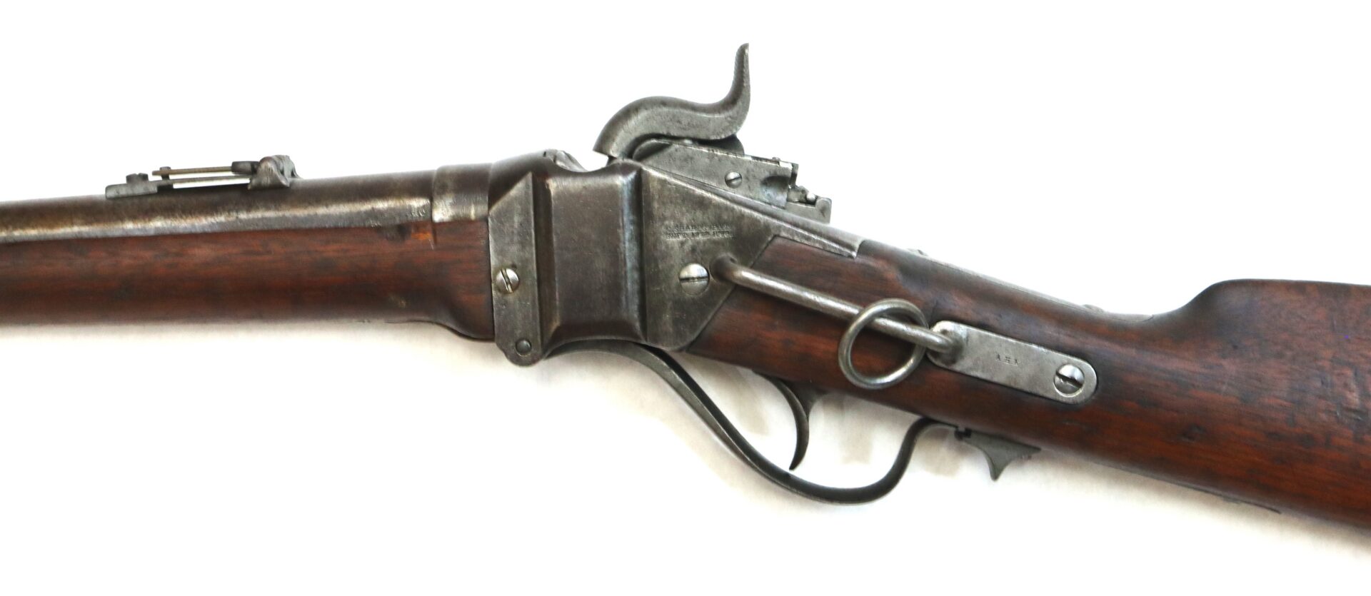 Side view of an antique lever-action rifle with a wooden stock and metal receiver, photographed against a white background.