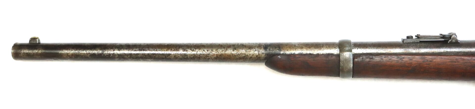 Close-up of the barrel and wooden stock of an antique rifle, showing metal sights and a worn, aged finish.