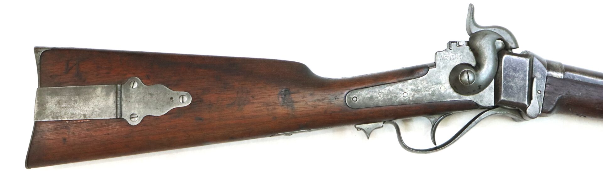 Side view of an antique rifle showing the wooden stock, metal buttplate, and trigger mechanism against a white background.