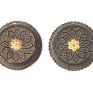 Two round, ornate metal buttons with a flower pattern in the center and detailed edges, displayed on a white background.