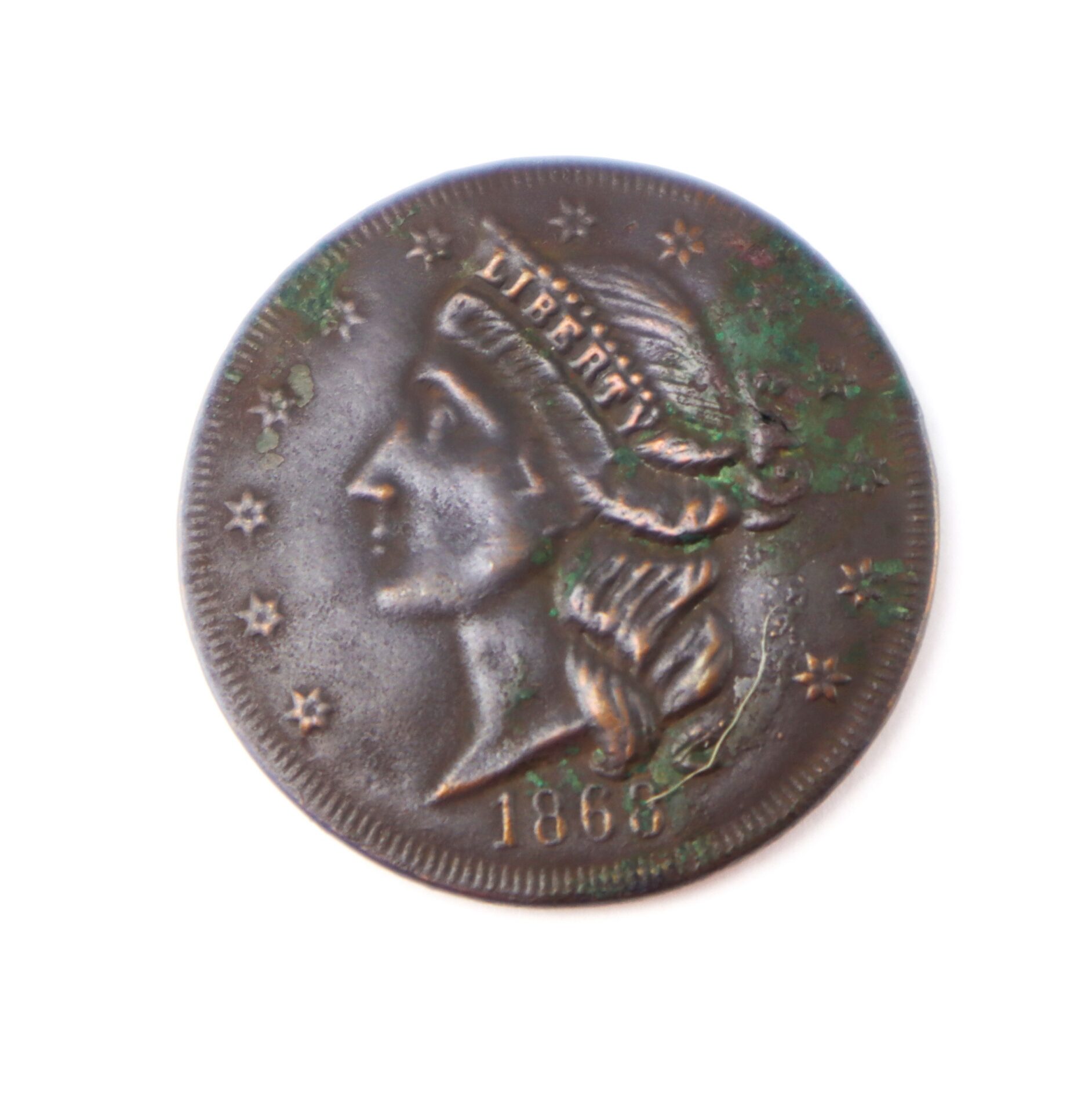 A worn 1868 US copper coin featuring the profile of Lady Liberty facing left, with stars around the edge and visible greenish corrosion spots.