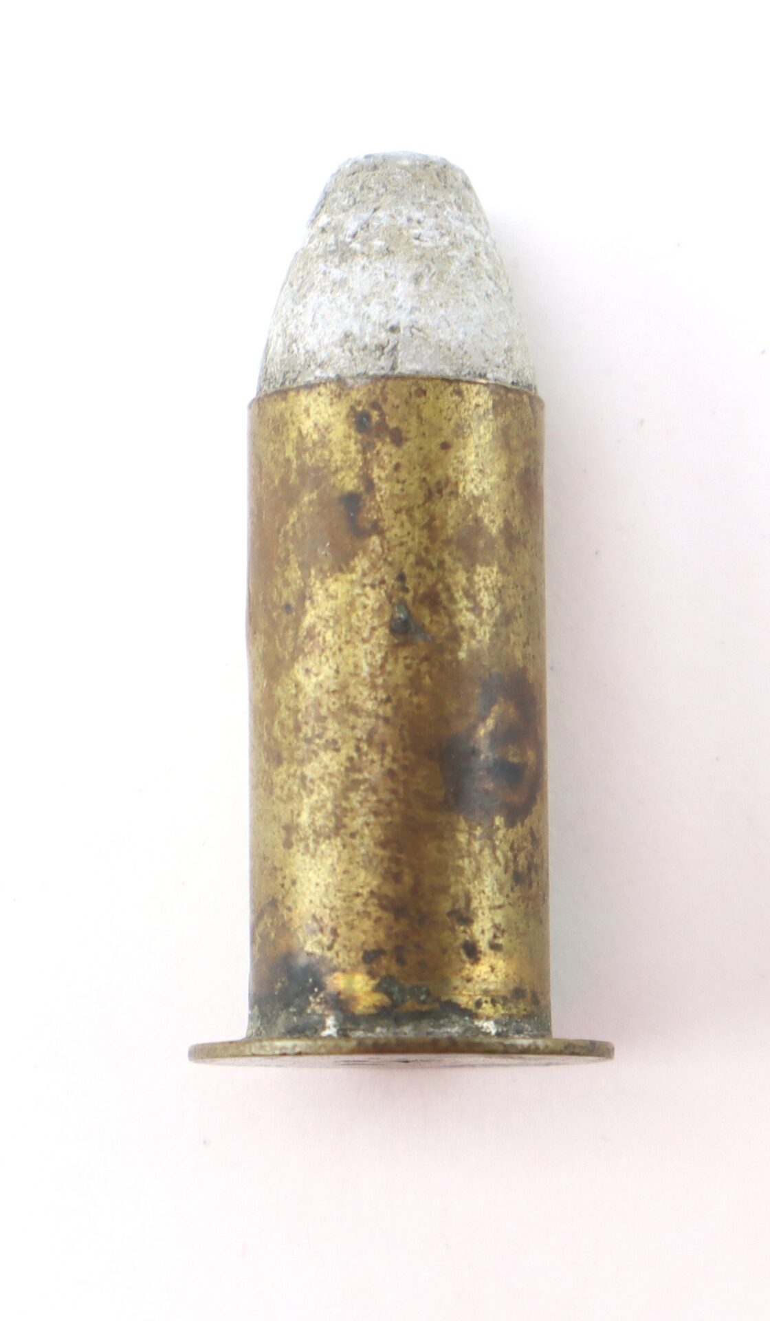 A single, tarnished brass cartridge with a lead bullet tip displayed upright against a plain background.