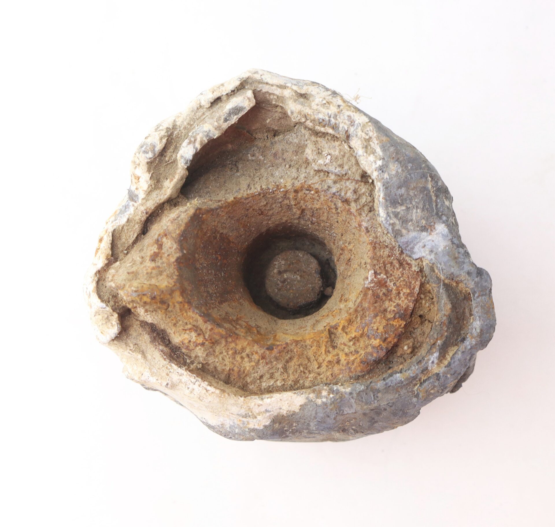 A weathered, roughly spherical rock with a deep central cavity and layered textures, displayed on a plain white background.