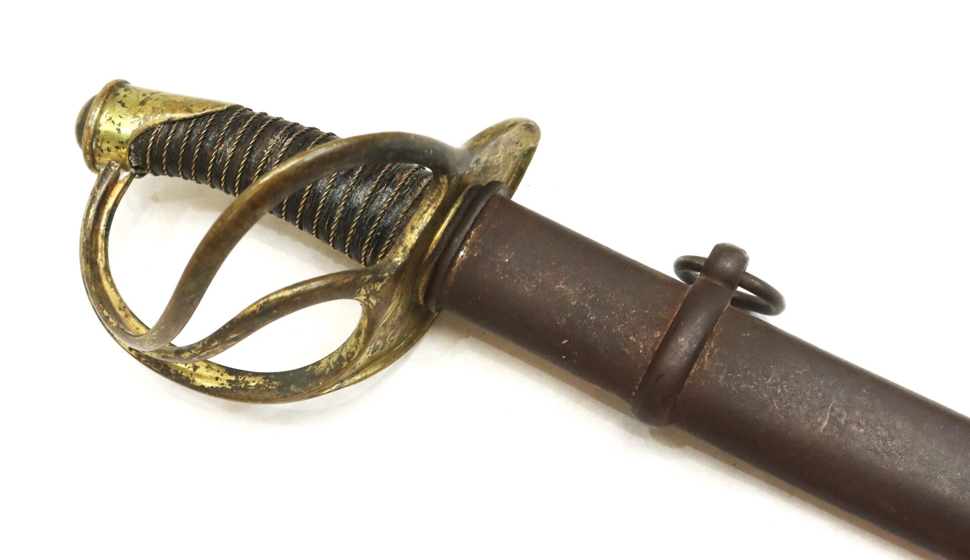 A brass-handled sword with a wire-wrapped grip and a protective guard, partially sheathed in a metal scabbard, on a white background.