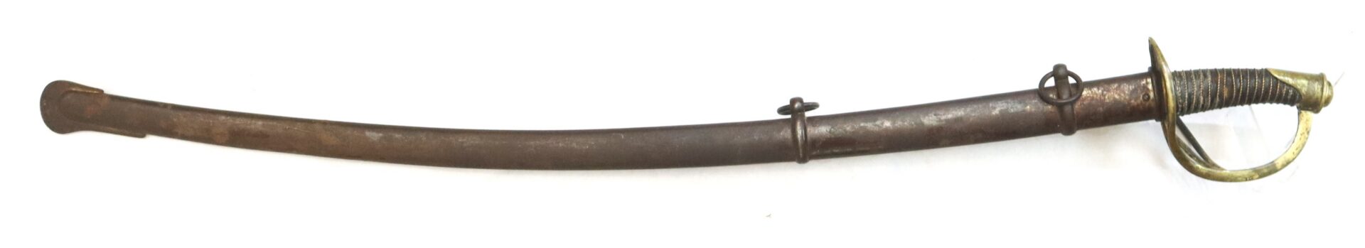 A vintage cavalry saber with a curved blade, brass handguard, and worn metal scabbard, shown against a white background.