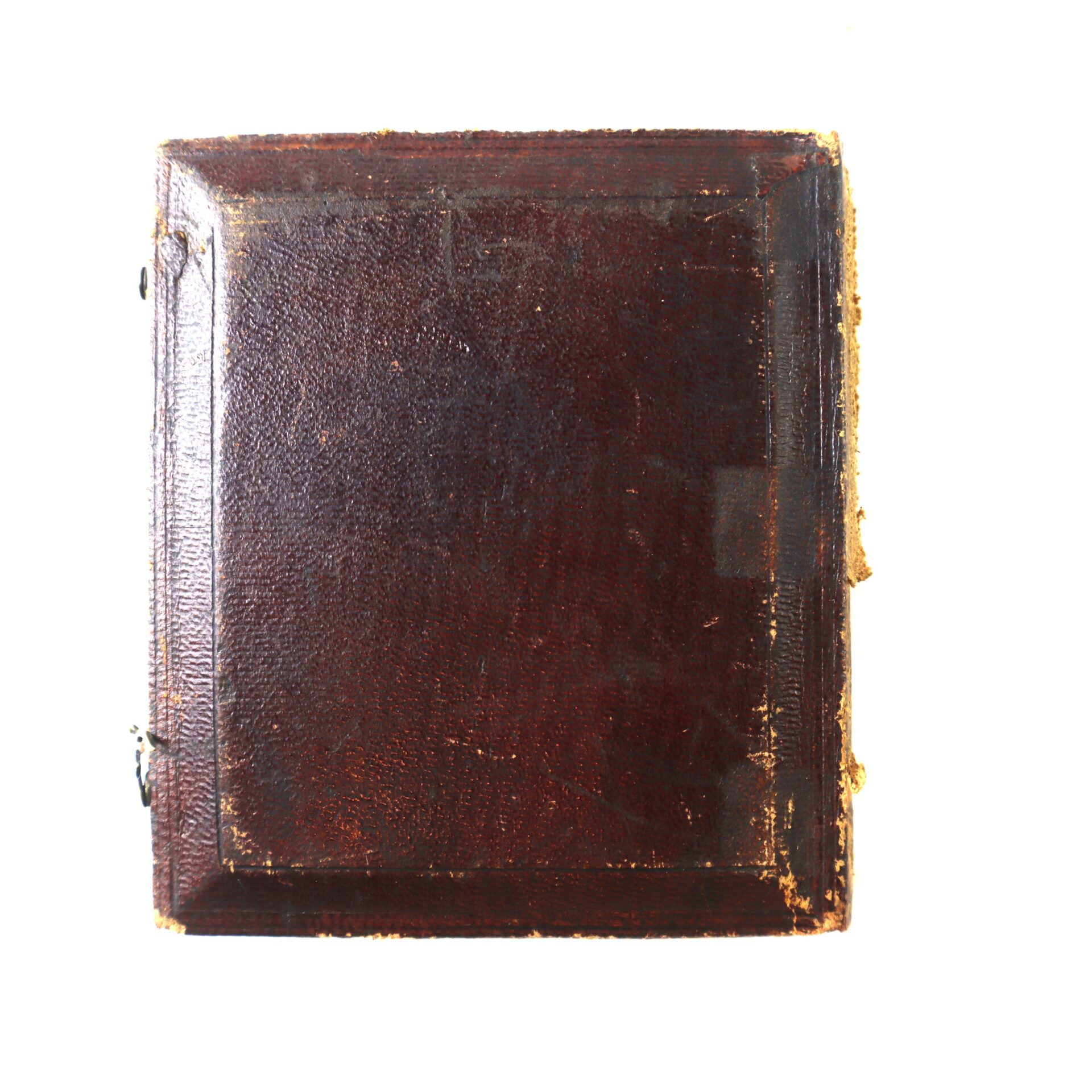 A closed, worn brown leather-bound book or album, possibly containing the Rare 1/6 Plate Daguerreotype of a Young Mulatto Girl, is displayed against a white background.