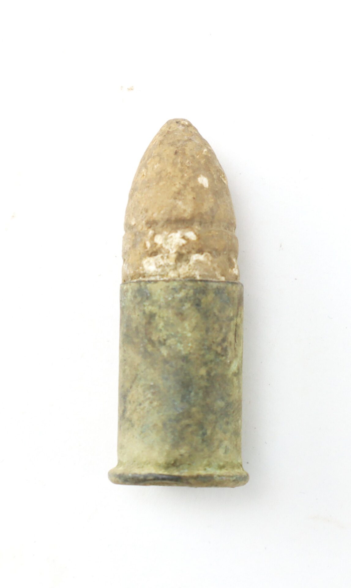 A single, aged and tarnished bullet with a rounded tip, photographed against a plain white background.