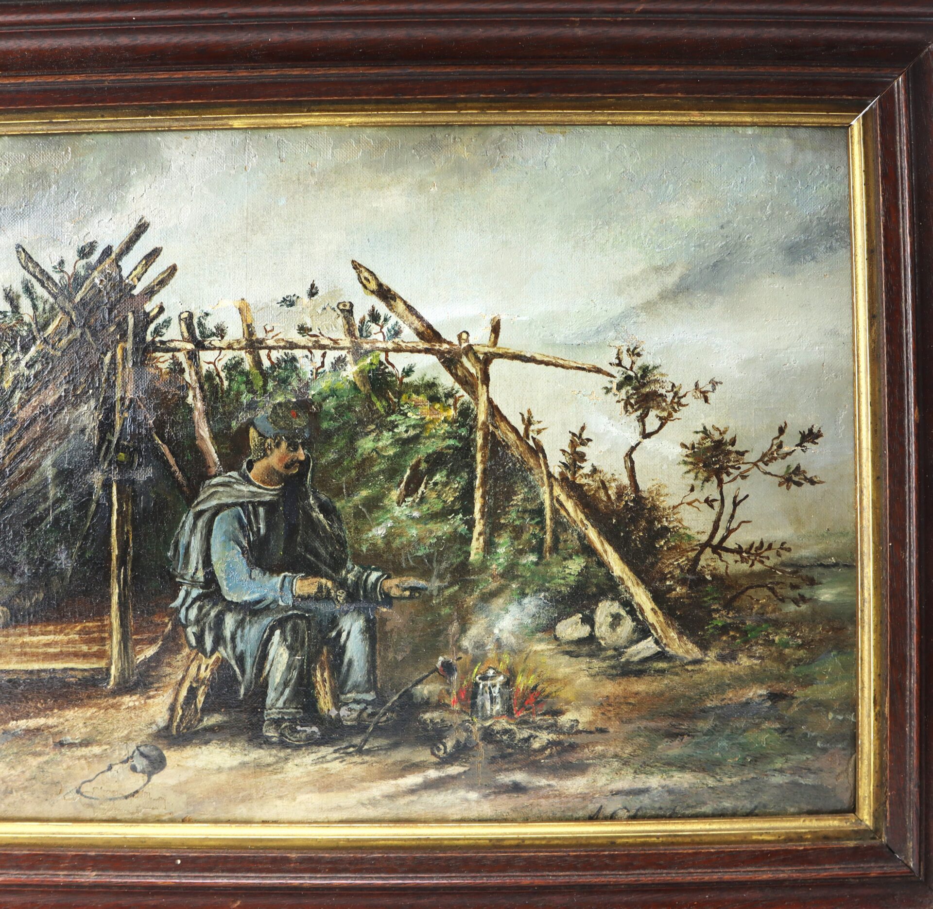 A man sits by a small campfire in front of a rustic shelter, cooking with a pot, surrounded by nature under a cloudy sky.