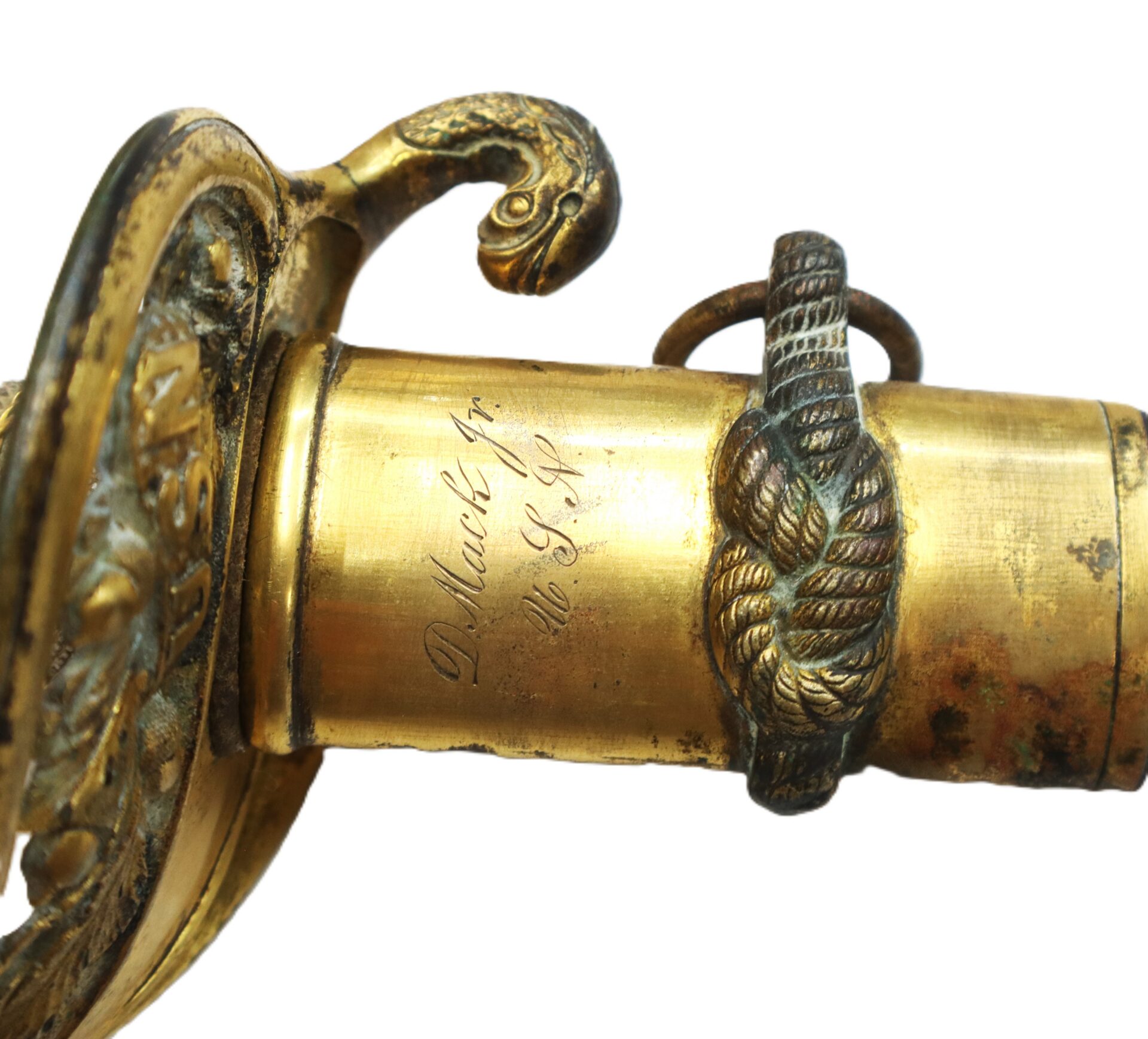 Close-up of an ornate brass sword hilt featuring engraved text, a rope knot design, and a decorative serpent detail.