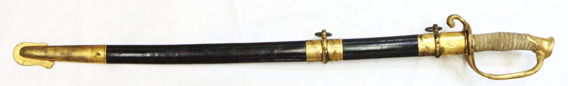 A ceremonial sword with a curved blade in a black and gold scabbard, featuring a gold hilt and textured grip, displayed on a white background.