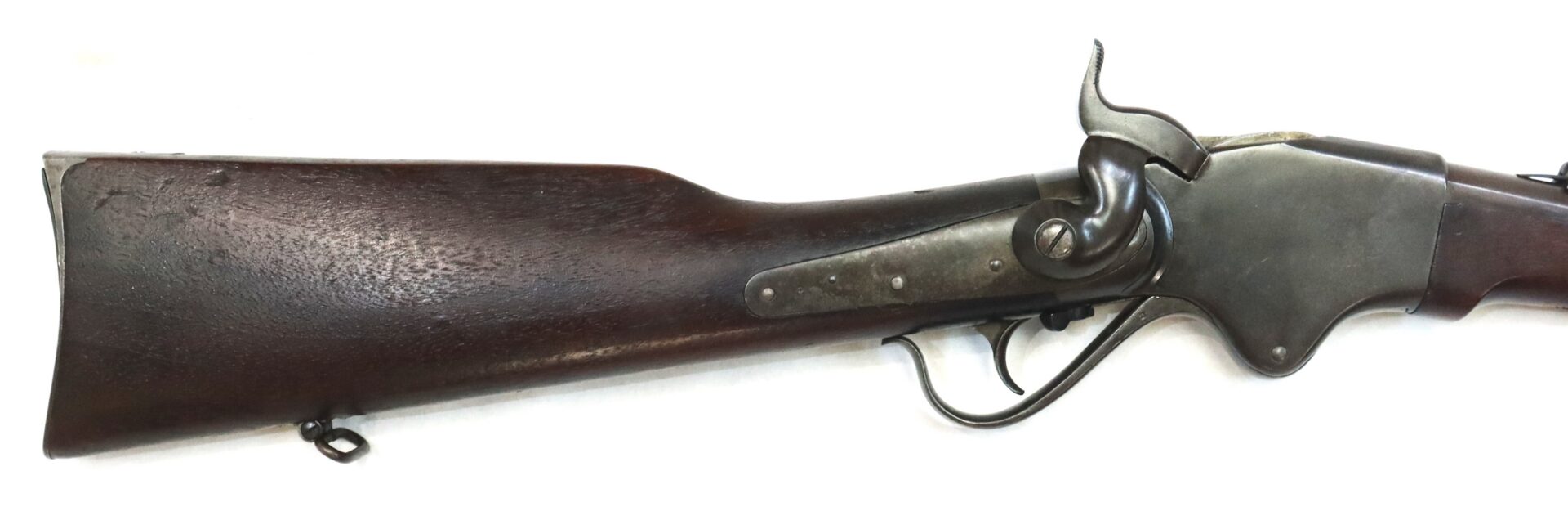 Side view of an antique rifle showing the wooden stock, metal receiver, and hammer, with visible trigger and lever against a white background.