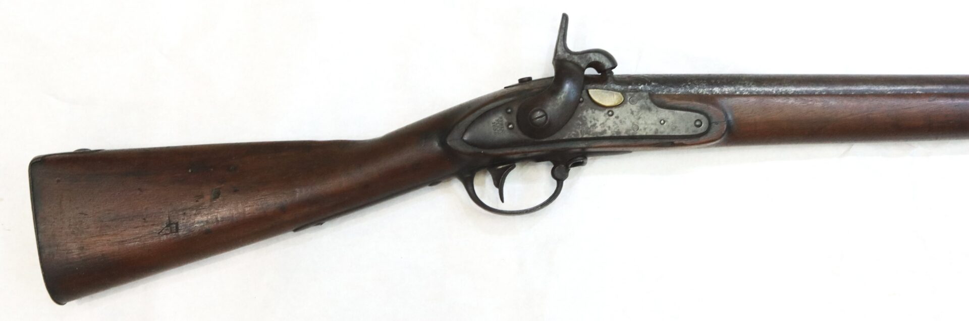 Side view of an antique percussion cap rifle with a wooden stock and a metal trigger mechanism, displayed on a plain white background.