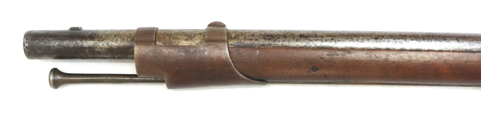 Close-up of the barrel and wooden stock of an antique rifle with an attached metal cleaning rod, shown against a white background.