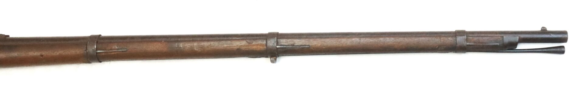 The image shows the barrel and front end of an old bolt-action rifle with a wooden stock and metal barrel bands against a white background.