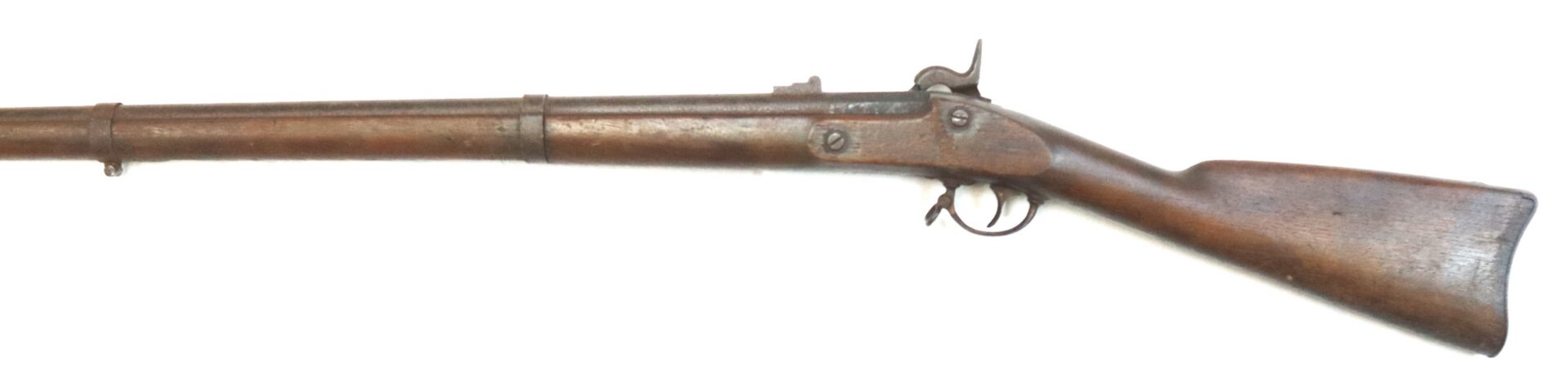 A vintage, wooden-stocked, single-shot rifle displayed on a white background, showing the barrel, trigger, and hammer mechanism.