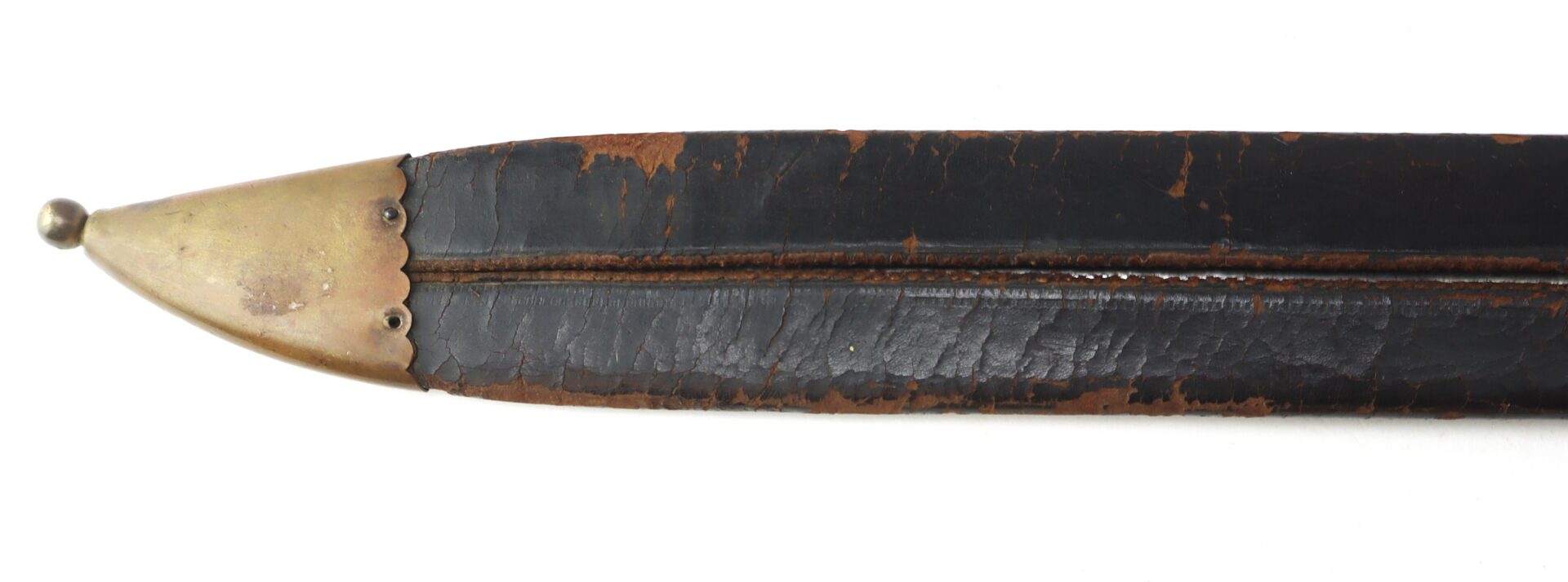 Close-up of an old, worn black leather sword scabbard with a brass tip, showing visible cracks and signs of age.