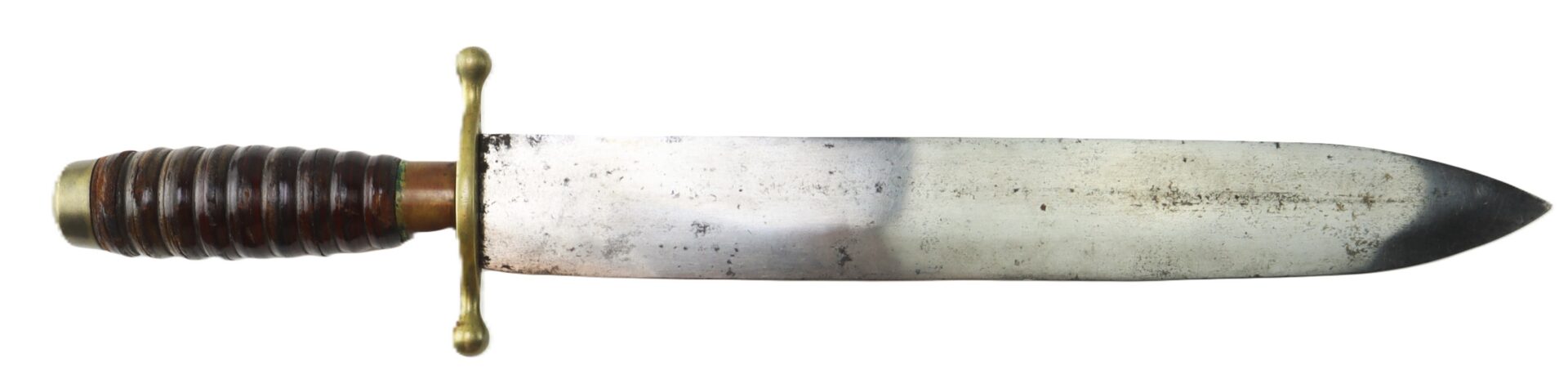 A vintage knife with a wide, straight blade, brass crossguard, and a ridged wooden handle.