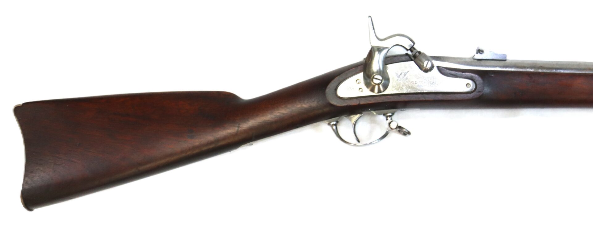 Side view of a vintage percussion cap rifle with a wooden stock and metal firing mechanism, isolated on a white background.