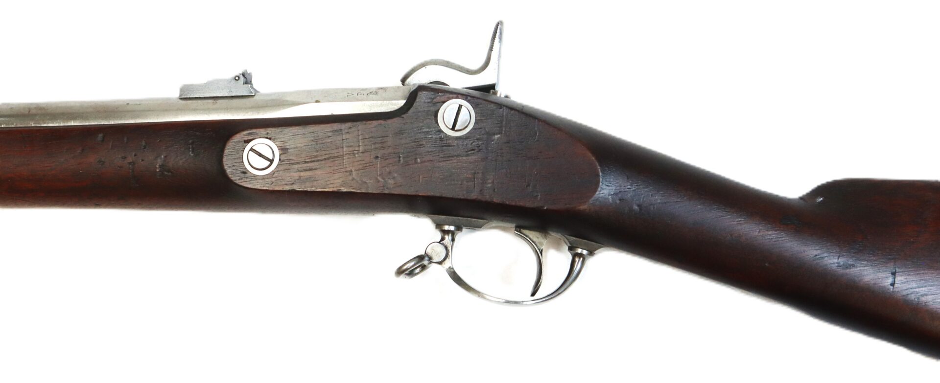 Side view of the trigger and lock mechanism of a vintage wooden rifle with metal hardware, photographed against a white background.