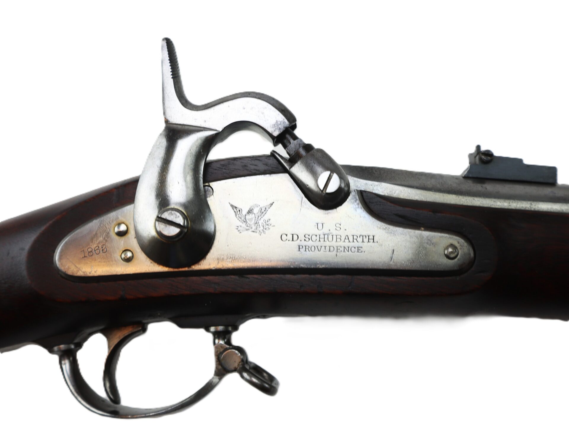 Close-up view of a vintage U.S. rifle lock plate, engraved with “C.D. SCHUBARTH, PROVIDENCE” and “1863,” showing metal and wooden parts.