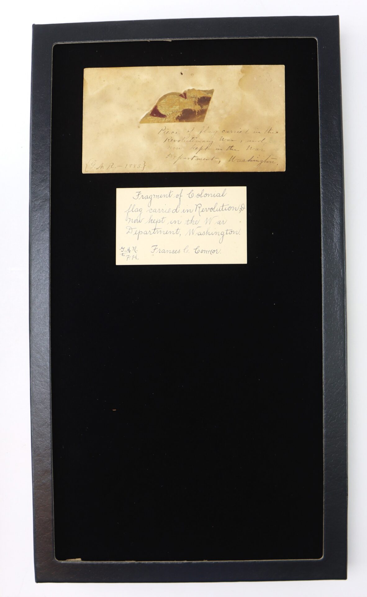 Framed display featuring an old envelope and a card labeling it as a “Fragment of Colonial flag raised at Yorktown,” offered as the Revolutionary War Flag Fragment with Exceptional 1883 Provenance.