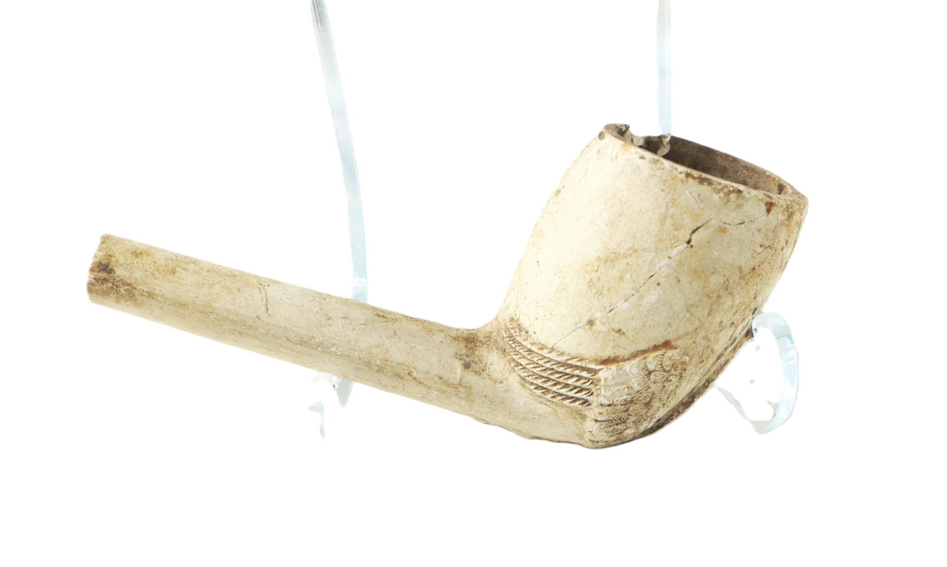 A clay tobacco pipe with a long straight stem and a rounded bowl, displayed on a clear plastic stand against a white background.