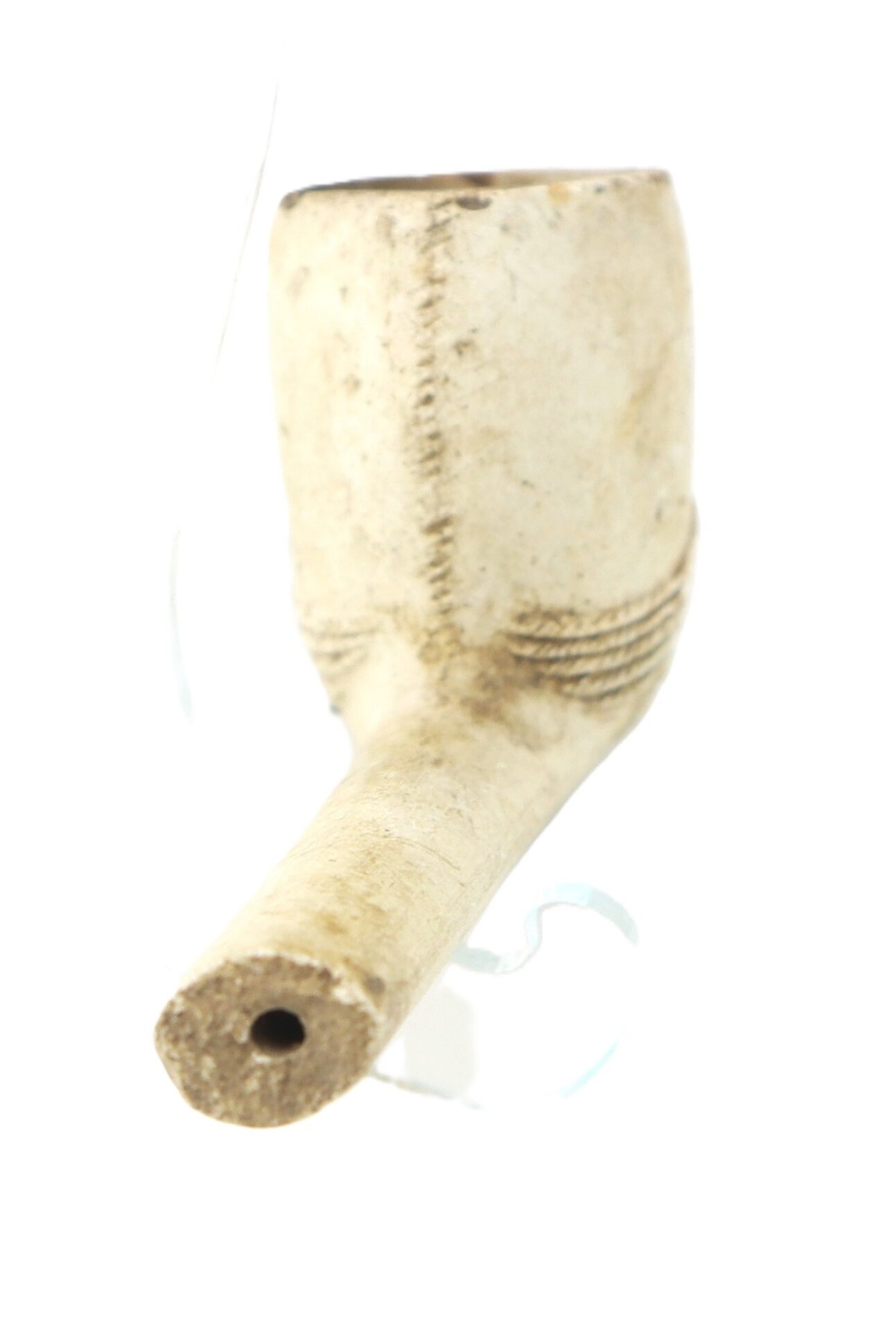 A close-up of a vintage clay tobacco pipe with a straight stem and bowl, photographed against a white background.