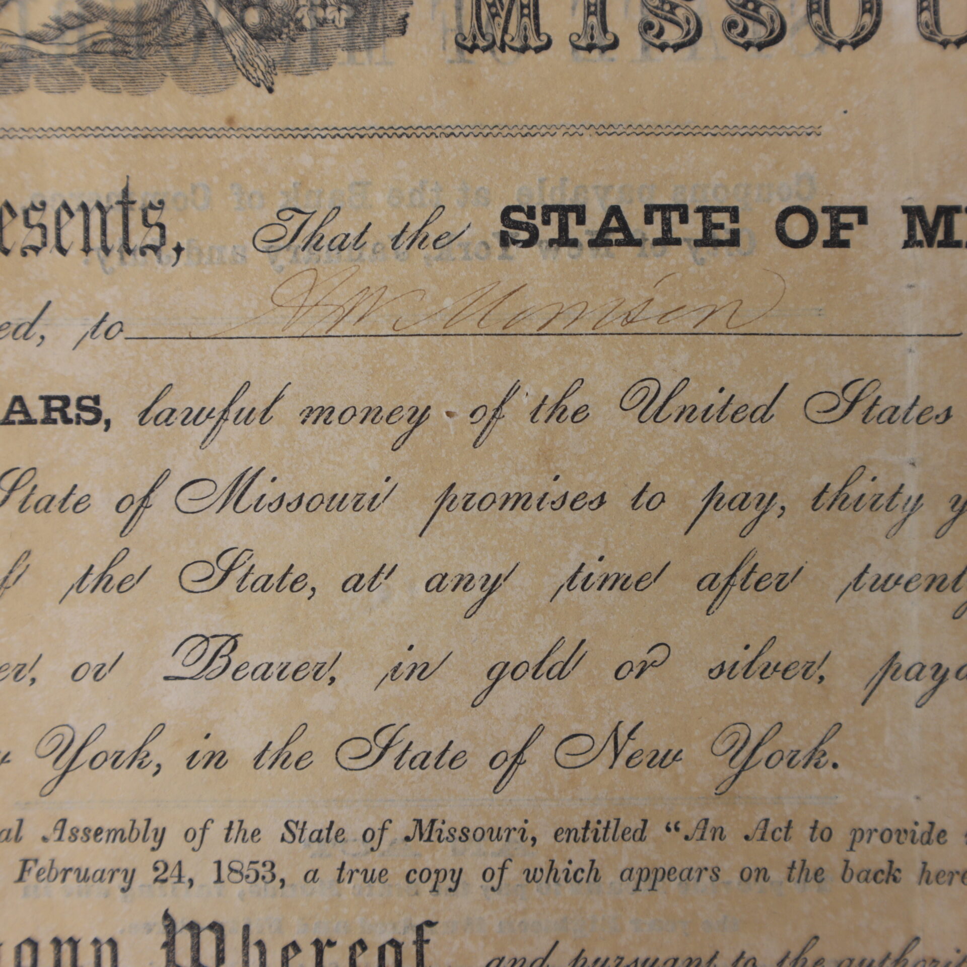 Close-up of an old Missouri financial document detailing a promise to pay a sum of money in gold or silver, with handwritten and printed text visible.