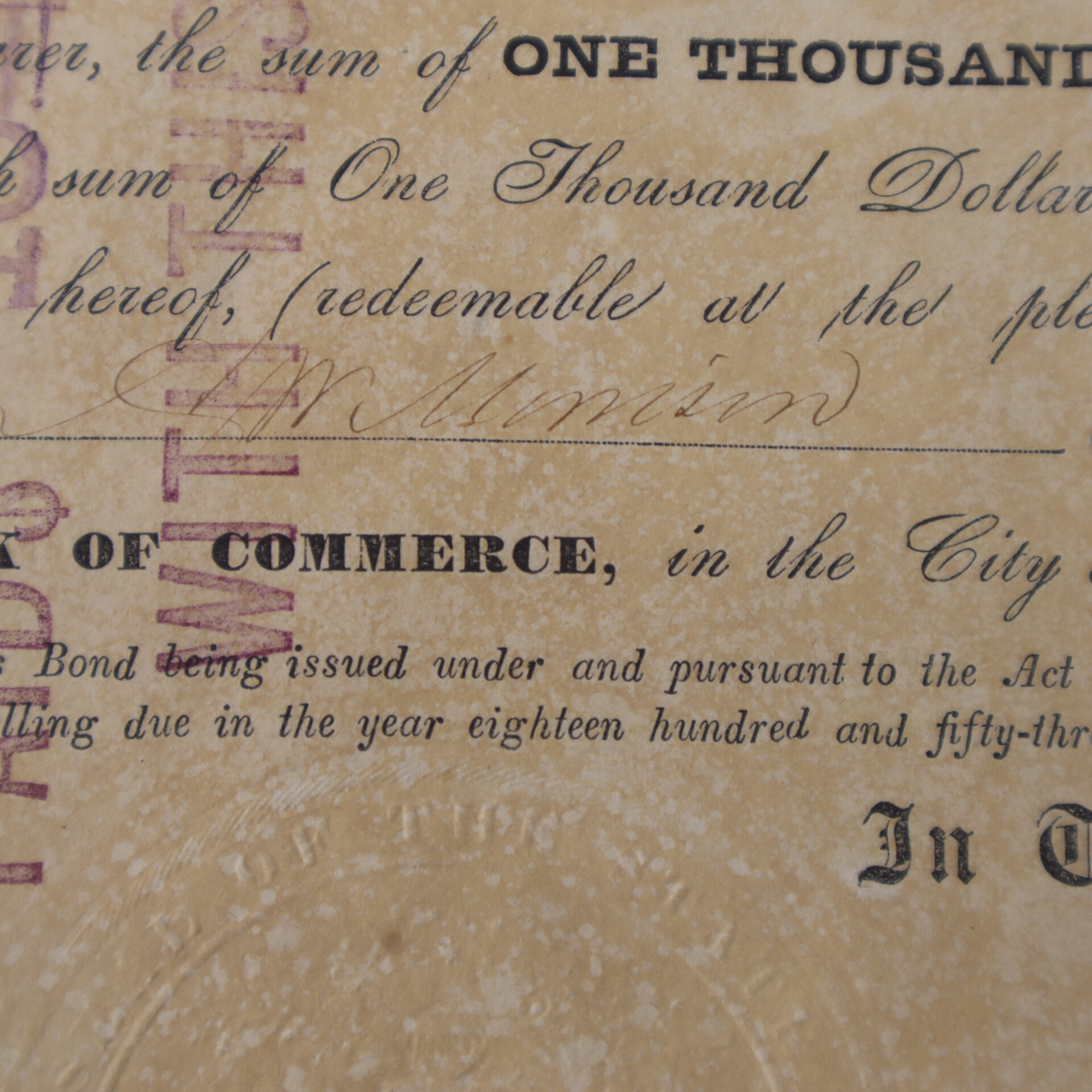 Close-up of an old, weathered financial document showing handwritten and printed text, including the words “one thousand,” “commerce,” and a signature.