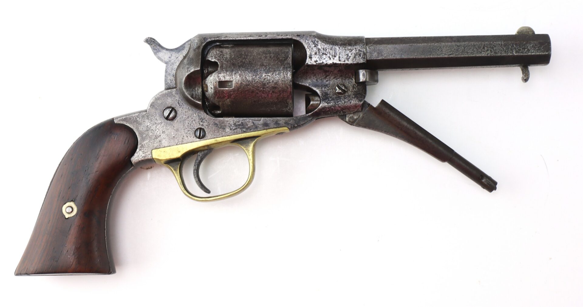 An antique six-shot revolver with a wooden grip, brass trigger guard, and a dark metal barrel, shown on a white background.