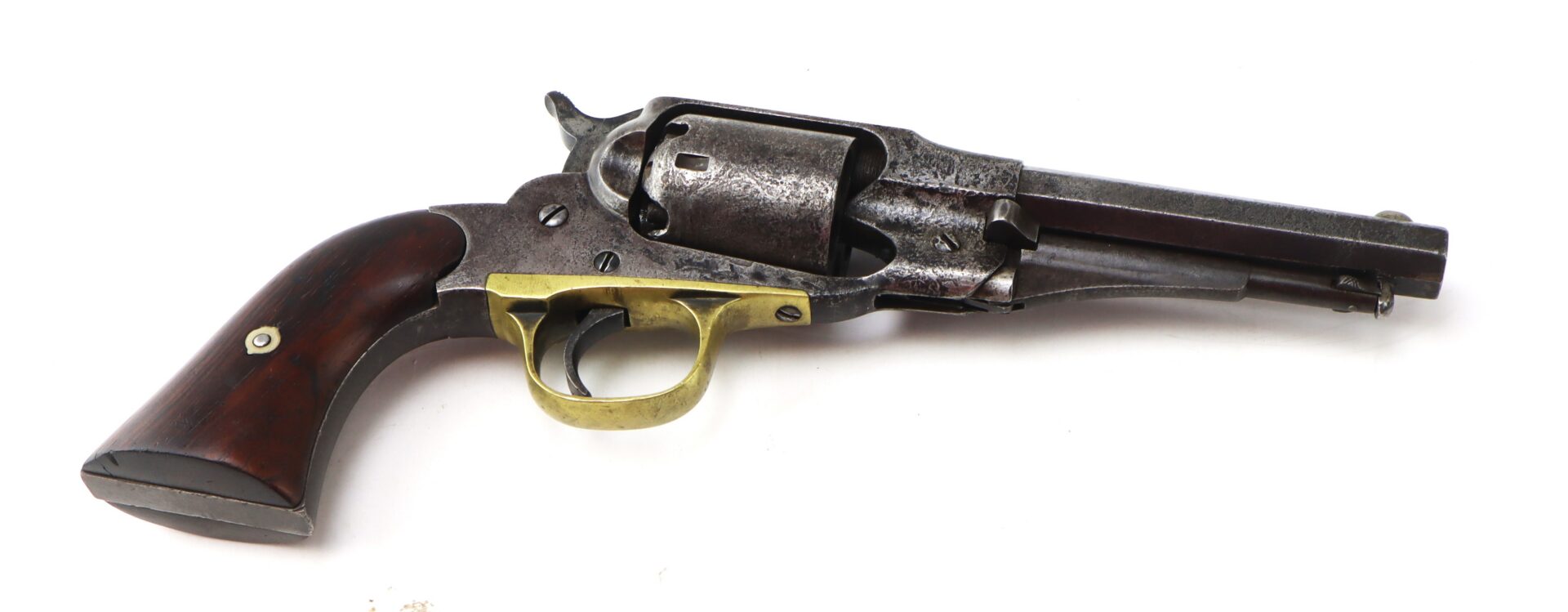 Antique revolver with a wooden grip, brass trigger guard, and a metal barrel and cylinder, displayed on a white background.