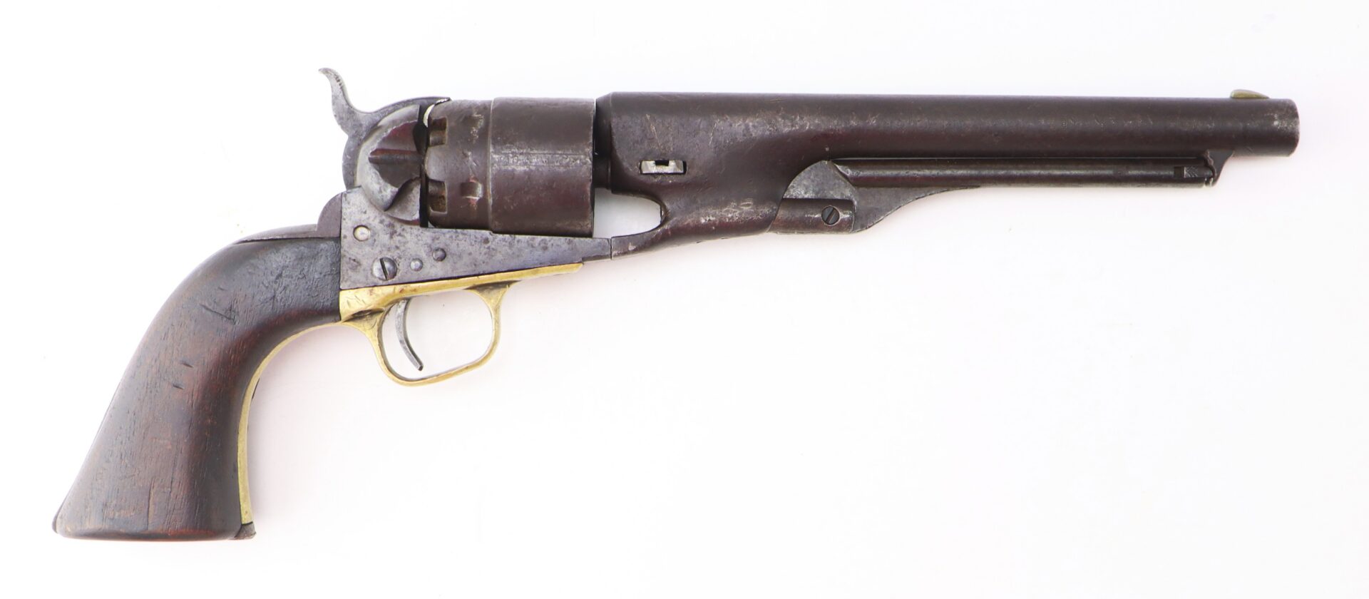 An antique black powder revolver with a wooden grip, metal barrel, and trigger, displayed against a white background.