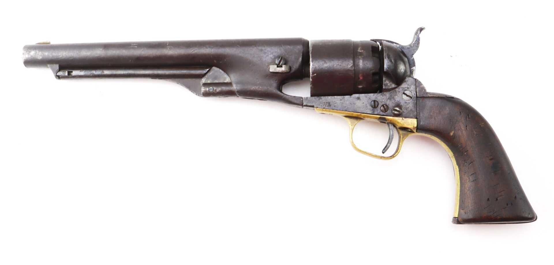 A vintage black powder revolver with a dark metal barrel, brass trigger guard, and wooden grip is shown on a white background.