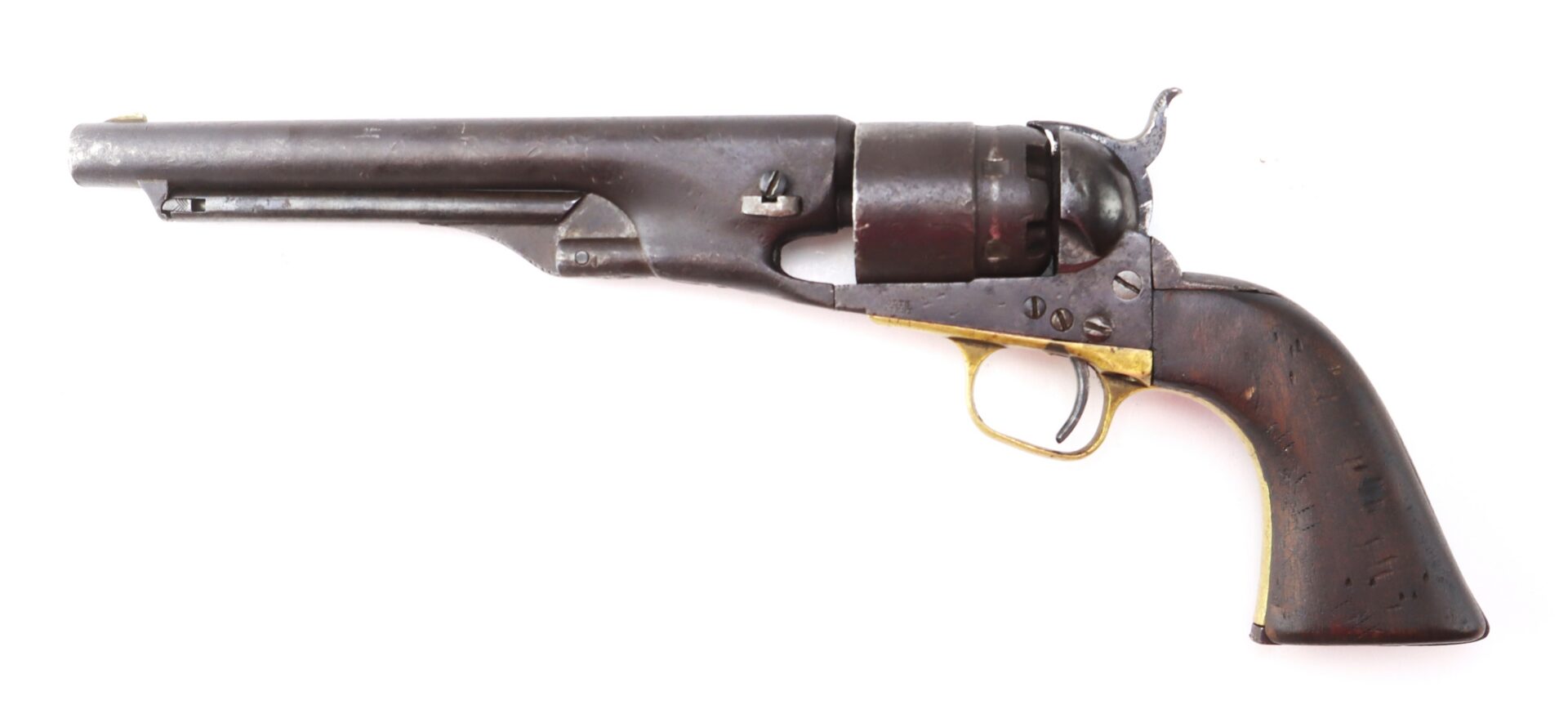 Antique black powder revolver with a wooden grip, brass trigger guard, and a long metal barrel, shown on a white background.