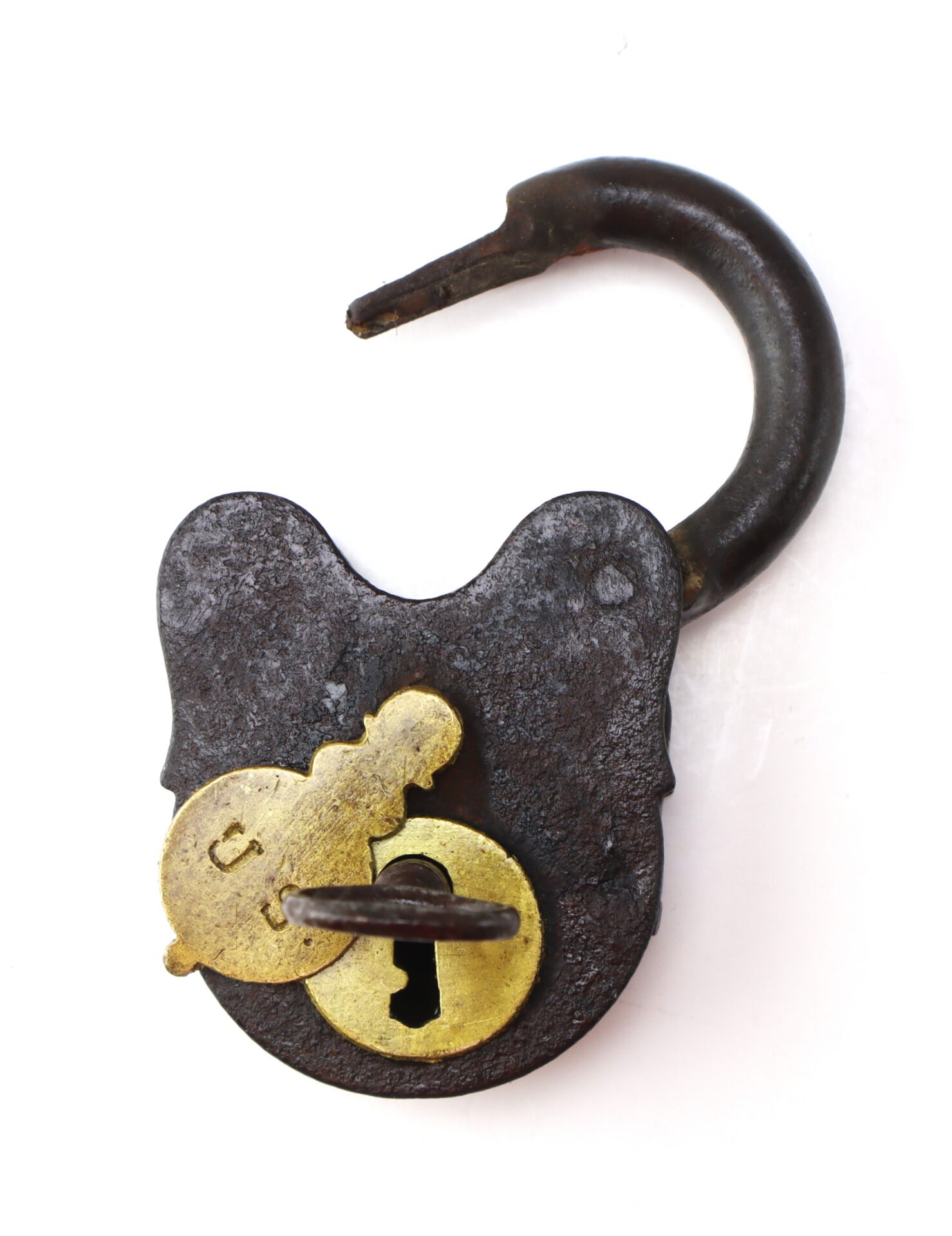 An old, rusted padlock with a brass key inserted, shown in an open position against a plain white background.