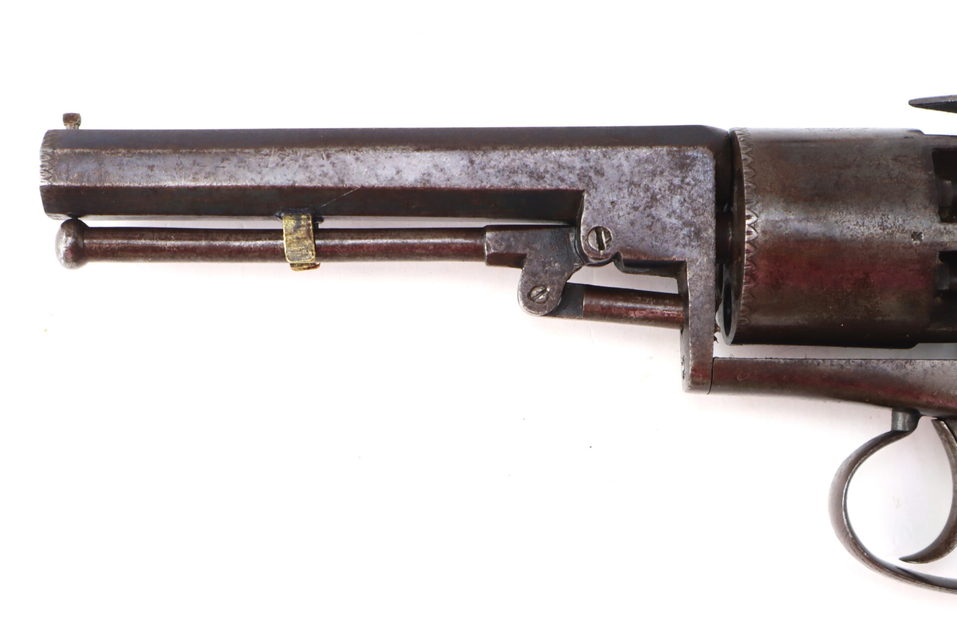 Close-up of the barrel and cylinder of an old, rusted revolver against a white background.